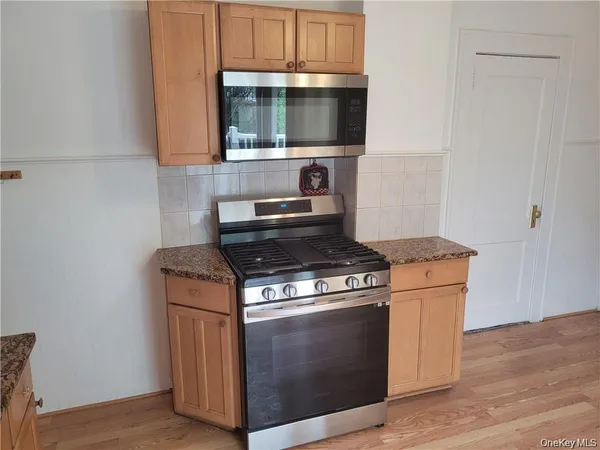 a kitchen with granite countertop a stove a sink and a granite counter top