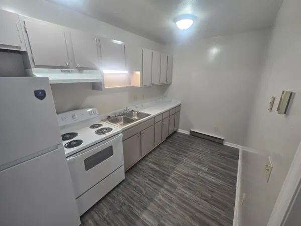 a kitchen with a stove and a refrigerator