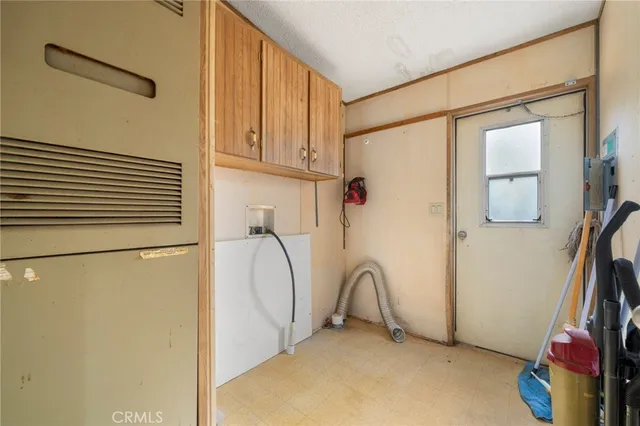 a bed sitting in a spacious bedroom next to a window