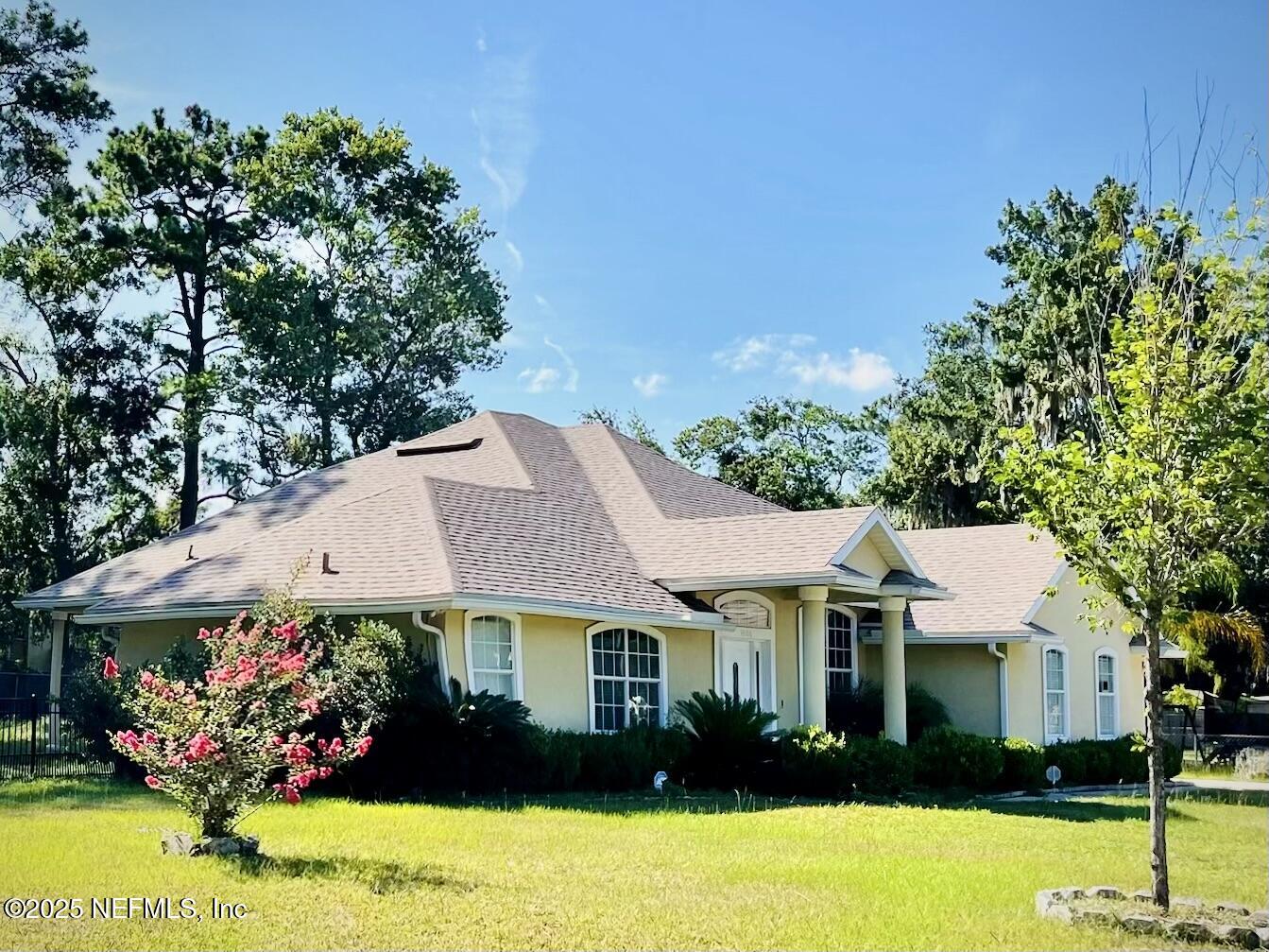 a front view of a house with a garden