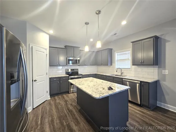 a kitchen with a stove sink and refrigerator