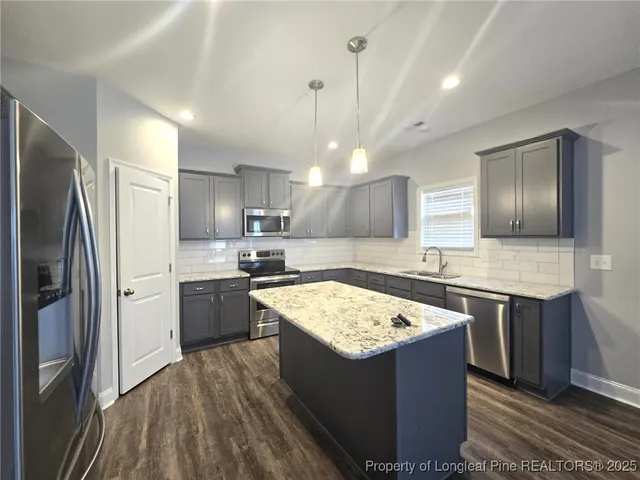 a kitchen with a stove sink and refrigerator