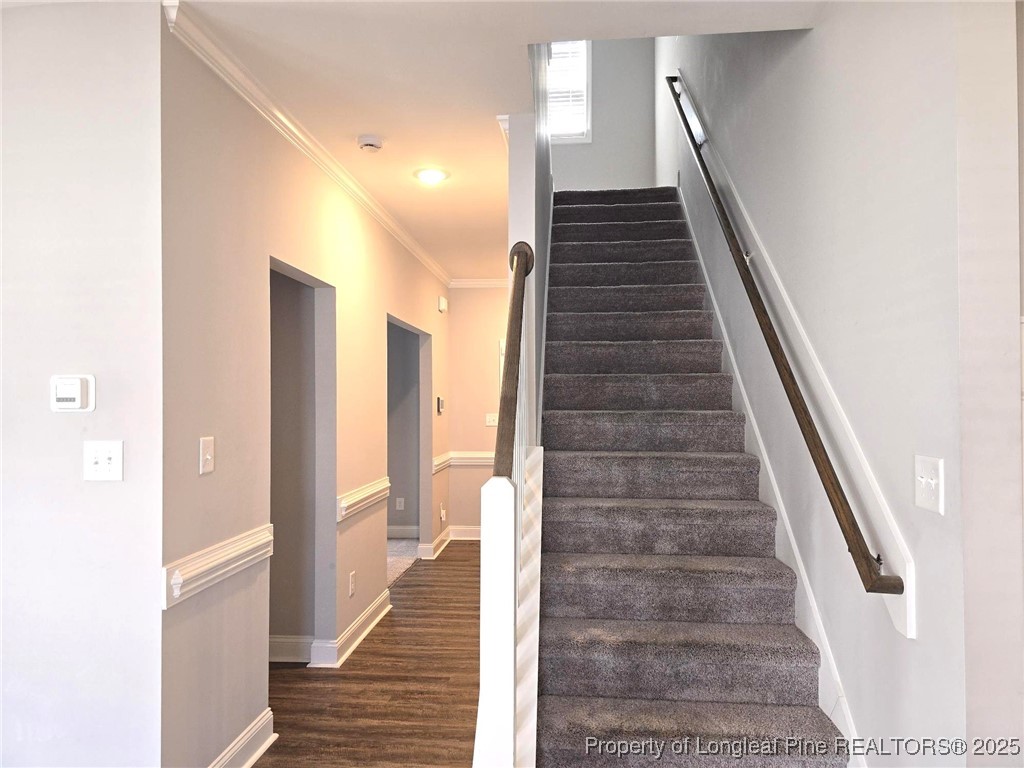 604 Amusement Drive Hope Mills, NC 28348 - Photo 20 of 41 a view of a hallway with wooden floor and staircase