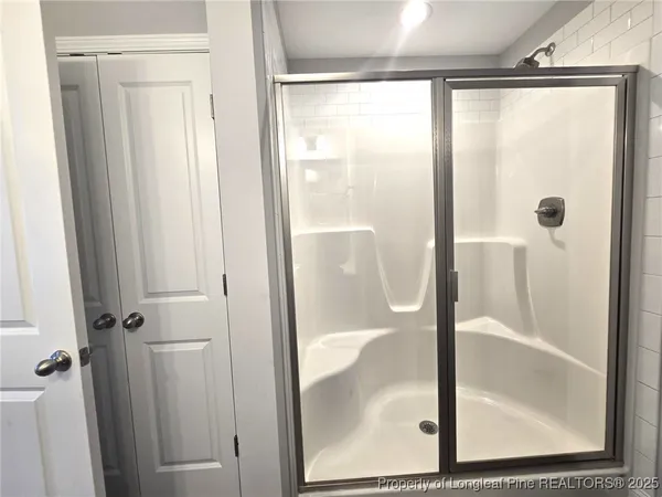 a bathroom with a glass shower door