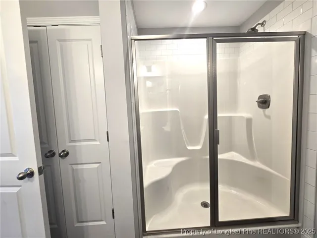 a bathroom with a glass shower door