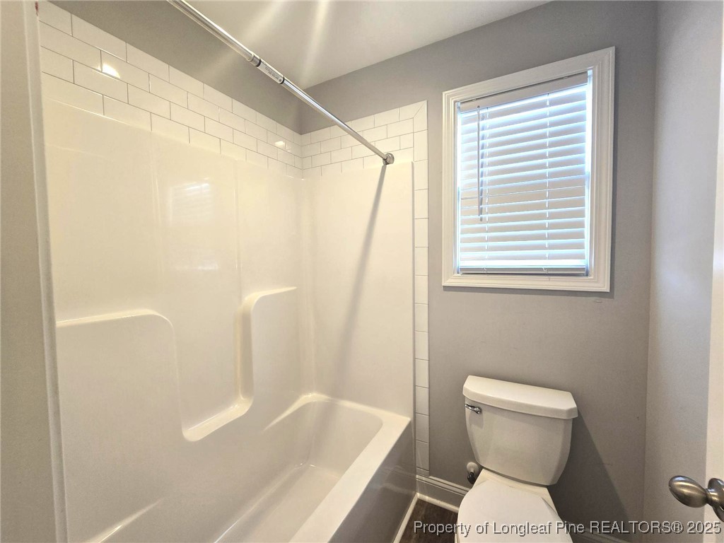 604 Amusement Drive Hope Mills, NC 28348 - Photo 33 of 41 a bathroom with a toilet and a bathtub