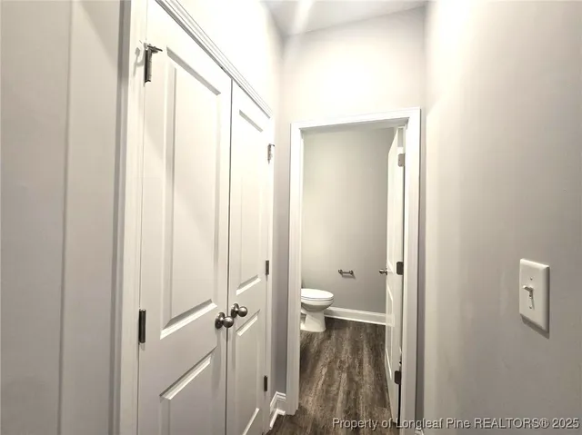 a bathroom with a granite countertop sink a toilet and shower