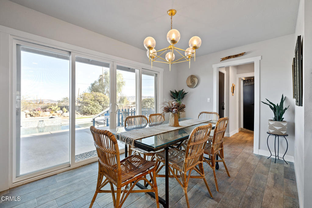 4741 Avenida Del Sol Joshua Tree, CA 92252 - Photo 12 of 52 a dining room filled chandelier and wooden floor