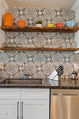 a dining room with furniture a chandelier and wooden floor