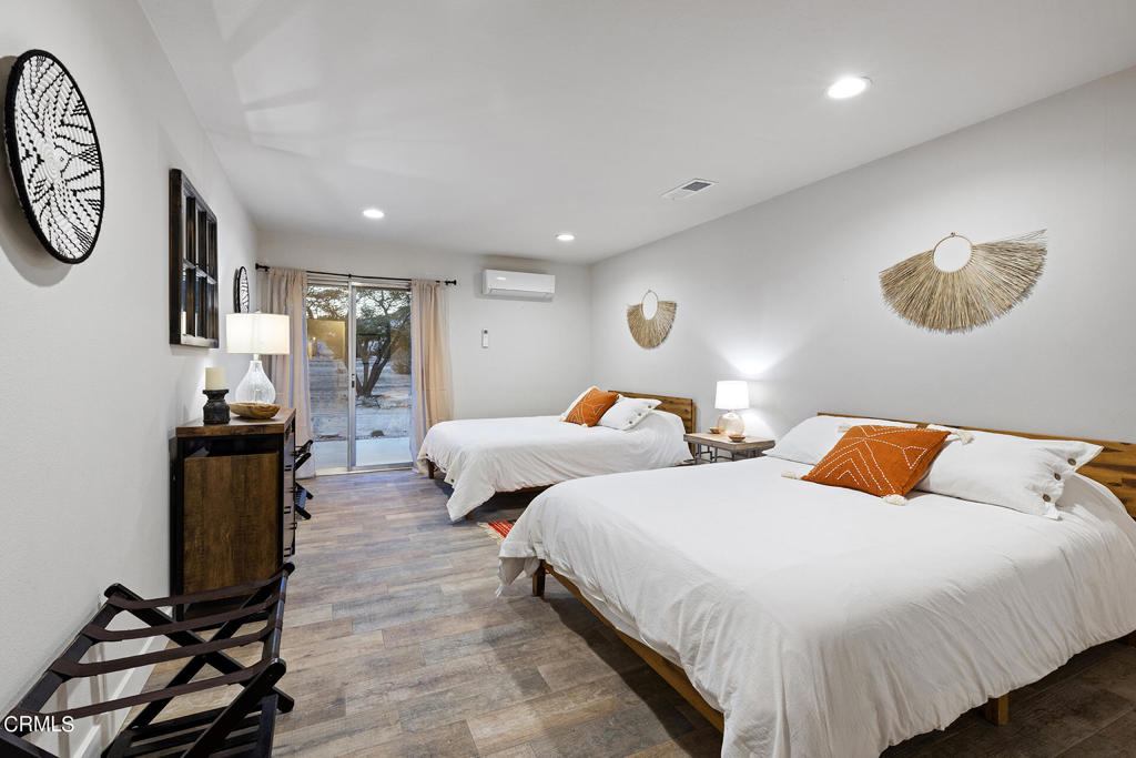 4741 Avenida Del Sol Joshua Tree, CA 92252 - Photo 18 of 52 a bedroom with two beds and a desk