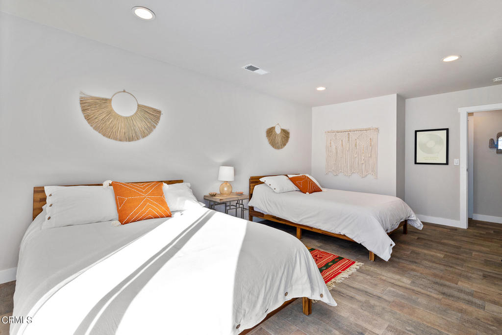 4741 Avenida Del Sol Joshua Tree, CA 92252 - Photo 19 of 52 a bedroom with two beds and painting on the wall