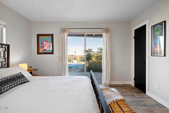 a bedroom with a bed and a table