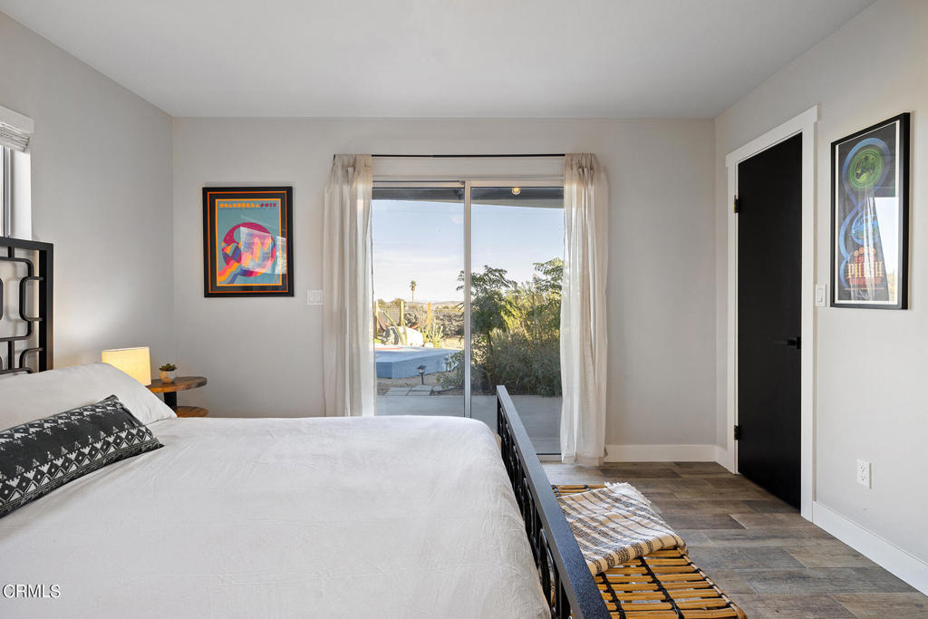 4741 Avenida Del Sol Joshua Tree, CA 92252 - Photo 21 of 52 a bedroom with a bed and a window