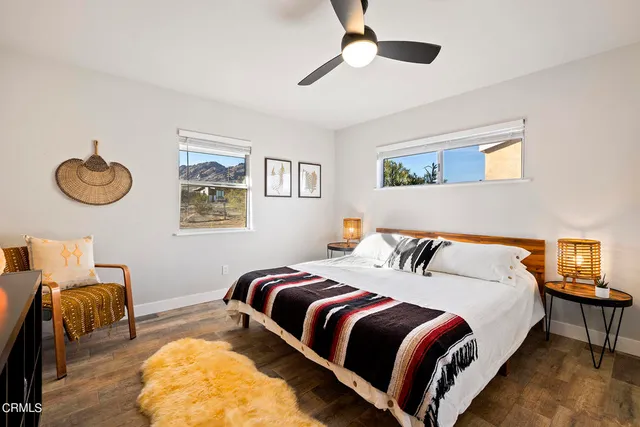 a bedroom with a large bed and a large window