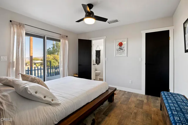 a bathroom with a granite countertop sink a toilet and a mirror