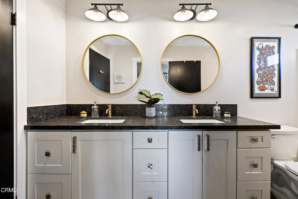 4741 Avenida Del Sol Joshua Tree, CA 92252 - Photo 25 of 52 a bathroom with a granite countertop sink and mirror