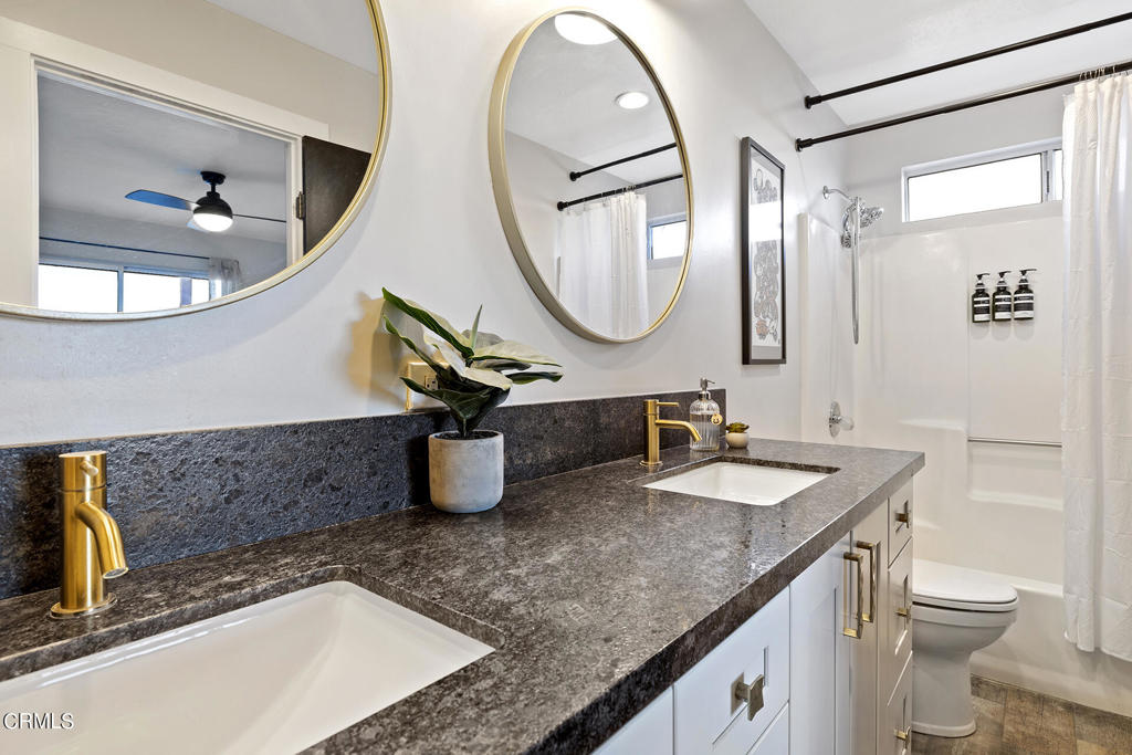 4741 Avenida Del Sol Joshua Tree, CA 92252 - Photo 26 of 52 a bathroom with a granite countertop sink a toilet and a mirror