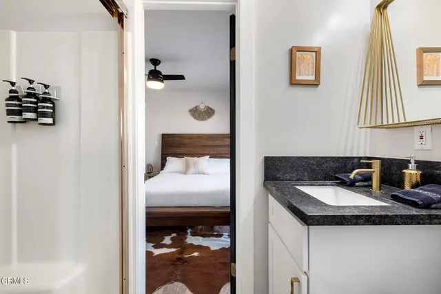 a view of a workspace with furniture and a window