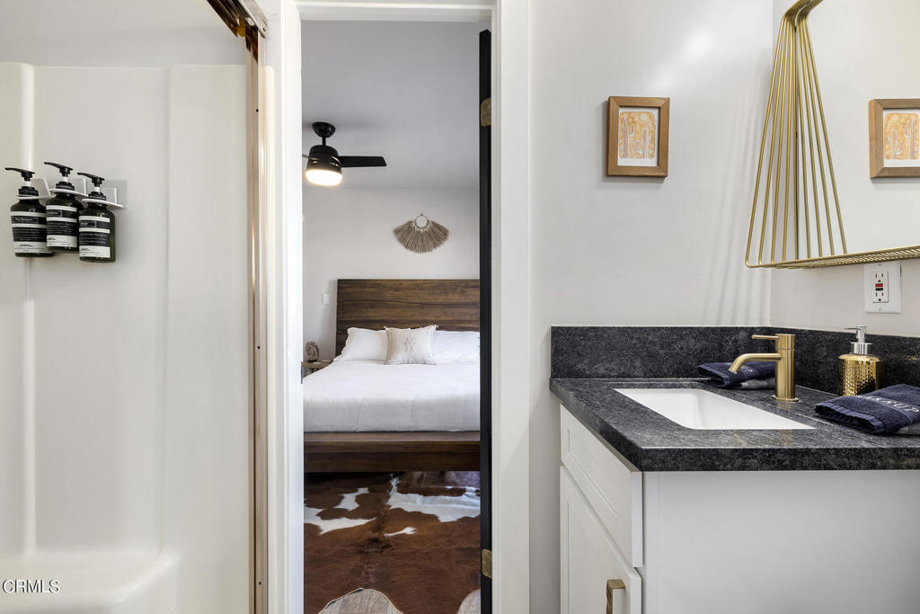 4741 Avenida Del Sol Joshua Tree, CA 92252 - Photo 27 of 52 a en suite bathroom with a sink and a mirror