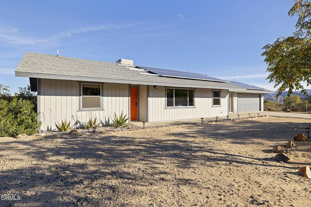 4741 Avenida Del Sol Joshua Tree, CA 92252 - Photo 3 of 52 a front view of a house with a patio