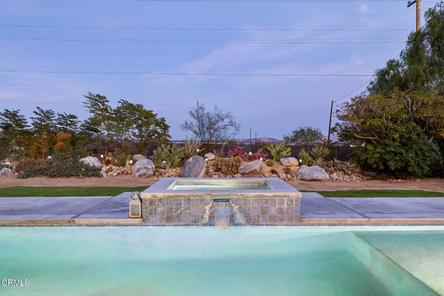 swimming pool with lawn chairs