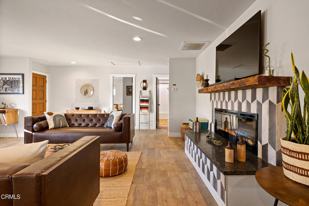 4741 Avenida Del Sol Joshua Tree, CA 92252 - Photo 6 of 52 a living room with furniture a flat screen tv and a fireplace