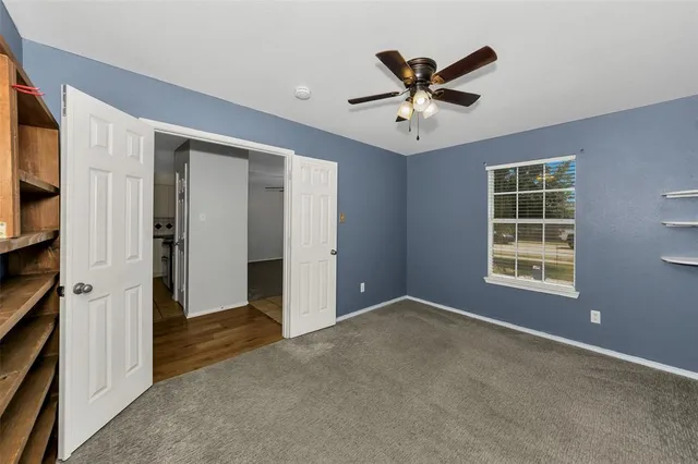 a bedroom with a bed and a chair