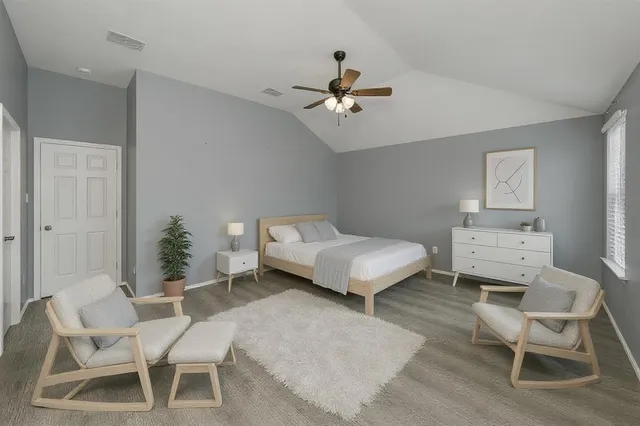 an empty room with a window and a ceiling fan