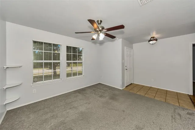 a view of empty room with ceiling fan