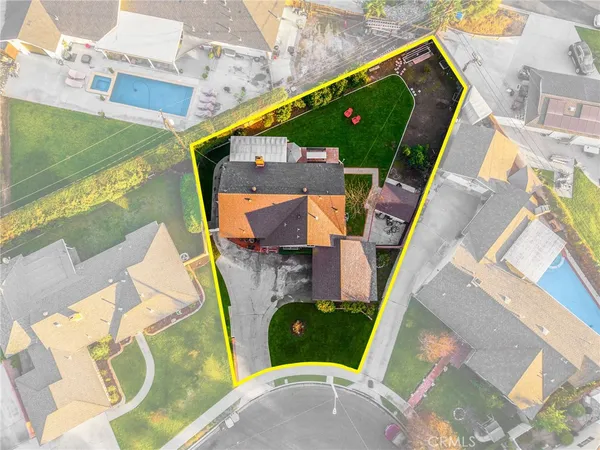an aerial view of a house with a garden and swimming pool