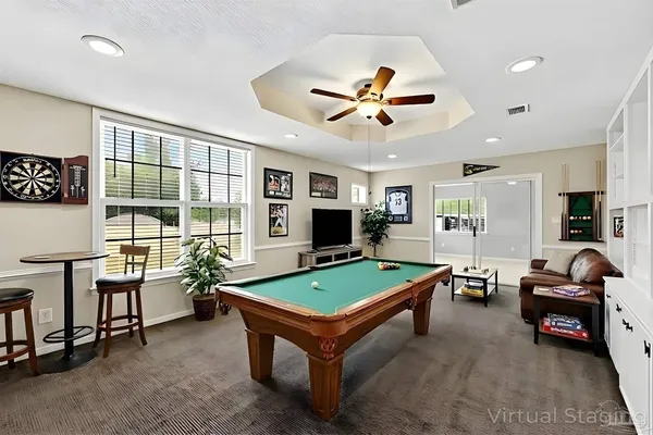 a house view with swimming pool in front of it