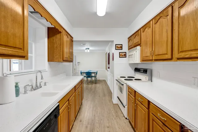 a kitchen with a sink a stove and cabinets