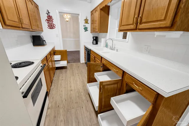 a view of a room with furniture and wooden floor