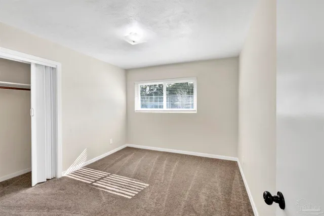 a view of a balcony with wooden floor and fence