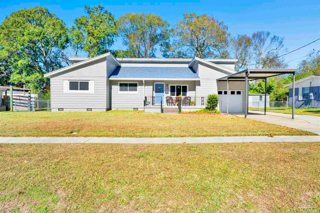 a house view with swimming pool in front of it
