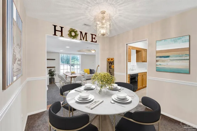 a view of a dining room with furniture a chandelier and wooden floor
