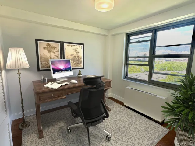 a workspace with furniture and a window