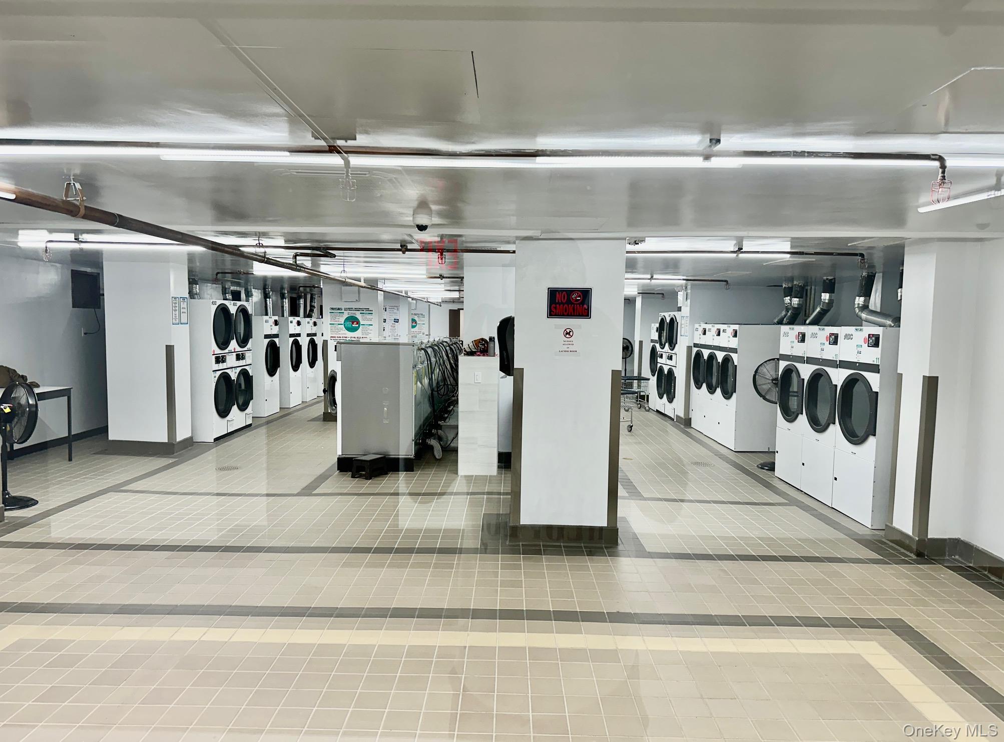 61-20 Grand Central Parkway, Unit A1402 Queens, NY 11375 - Photo 6 of 8 a view of a storage room with washer and dryer