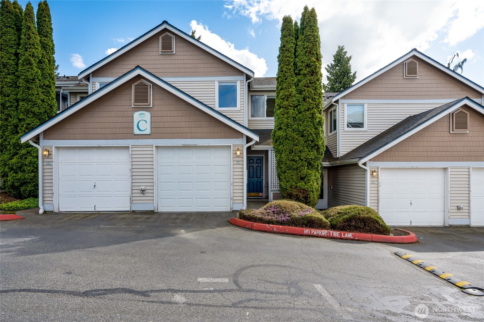 23908 Bothell Everett Highway, Unit C4 Bothell, WA 98021 - Photo 1 of 33 a view of a house with garage and yard