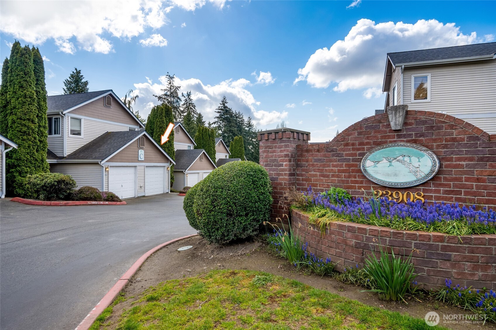23908 Bothell Everett Highway, Unit C4 Bothell, WA 98021 - Photo 3 of 33 a view of a house with a small yard and a large tree