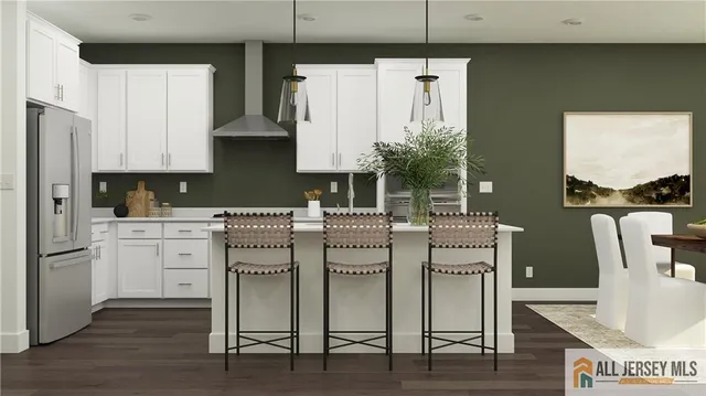 a kitchen with cabinets and wooden floor