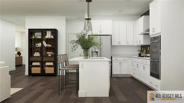a kitchen with a white wooden cabinets and table chair