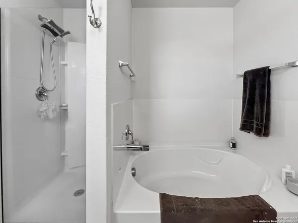 a bedroom with a large bed chandelier and a window