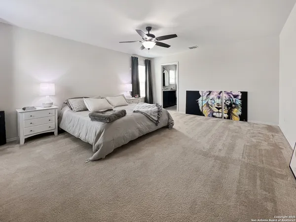 a bedroom with bed and a chandelier