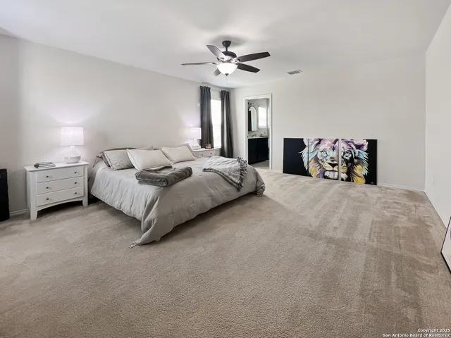 a bedroom with bed and a chandelier