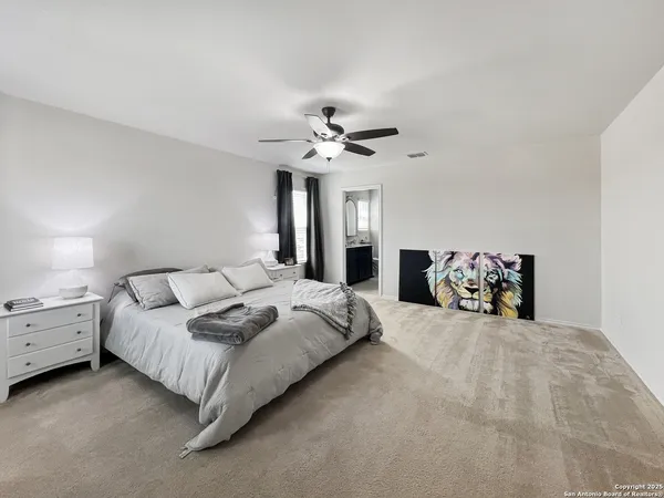 a bedroom with a bed and ceiling fan