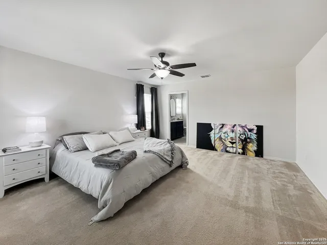 a bedroom with a bed and ceiling fan