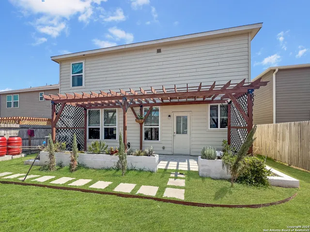 an aerial view of a house with a yard