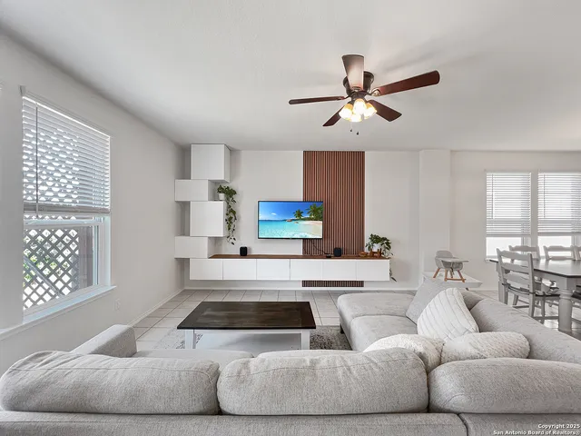 a living room with furniture and a large window