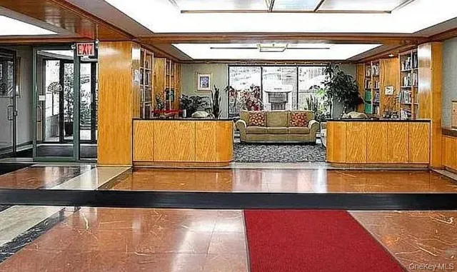 a view of a living room and kitchen with furniture